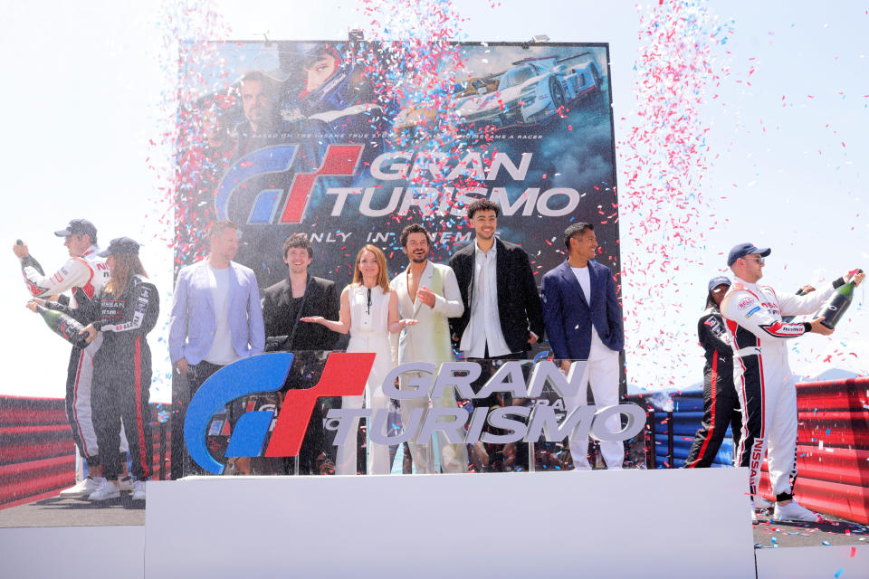 From left, in front of sign: ‘Gran Turismo’s Neill Blomkamp, Maximilian Mundt, Geri Halliwell, Orlando Bloom, Archie Madekwe and Asad Qizilbash