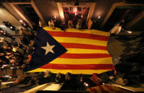 People carry a giant Estelada (Catalan separatist flag) during a torch march in Vilafranca del Penedes, Spain, September 10, 2017. REUTERS/Albert Gea