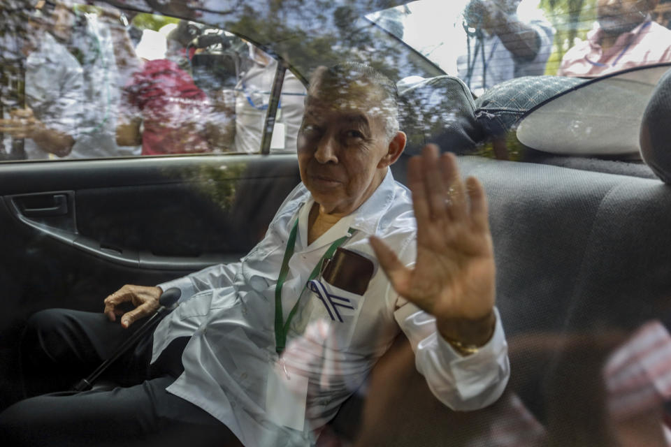 Dr. Carlos Tunnerman, a member of the opposition Civic Alliance, waves from the backseat of car after taking part in a day of negotiations in Managua, Nicaragua, Thursday, Feb. 28, 2019. Nicaraguan government and opposition representatives began a second day of negotiations Thursday on resolving the country's political standoff, amid an atmosphere of rumor, secrecy and an early lack of consensus on key points. (AP Photo/Alfredo Zuniga)