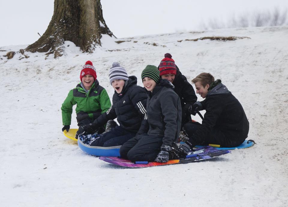 Friends sled at Antrim Park in Columbus