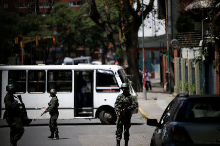 Venezuelan soldiers stand outside a school where a polling center will be established for a Constitutional Assembly election next Sunday, in Caracas, Venezuela, July 24, 2017. REUTERS/Andres Martinez Casares