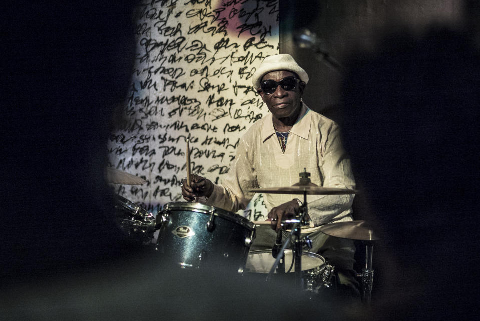 In this photo taken Saturday, April 8, 2017, pioneering African drummer Tony Allen, whose influential career spanned decades and continents, plays in concert with Senegalese musician Cheikh Lo in Dakar, Senegal. Tony Allen, the driver of the Afrobeat sound who formed a partnership with guitarist and composer Fela Kuti, died of aortic failure at the Pompidou Hospital in Paris aged 79 on Thursday night, his manager Eric Trosset confirmed to The Associated Press on Friday, May 1, 2020. (AP Photo/Sylvain Cherkaoui)