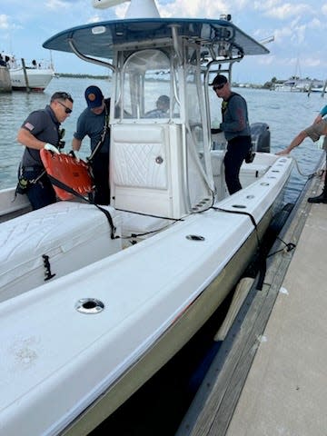 Vero Beach friends Kyle Purvis, Cody King, and Brandon Keller rescue St. Lucie County Deputy Ryan Betsinger from the Indian River Lagoon on Wednesday, April 17, 2024. Betsinger was thrown overboard and injured when his boat hit a large wave.