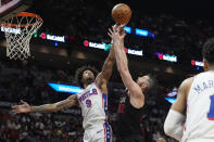 Philadelphia 76ers guard Kelly Oubre Jr. (9) and Miami Heat forward Kevin Love (42) go after a rebound during the first half of an NBA basketball game, Thursday, April 4, 2024, in Miami. (AP Photo/Marta Lavandier)
