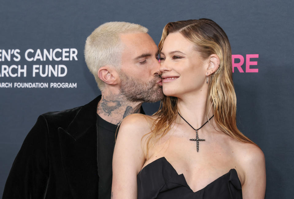 Adam kissing Behati's cheek