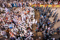 Supporters of Islami Andolan Bangladesh, an Islamist political party, face policemen during a protest against French President Emmanuel Macron and against the publishing of caricatures of the Prophet Muhammad they deem blasphemous, in Dhaka, Bangladesh, Tuesday, Oct. 27, 2020. Muslims in the Middle East and beyond on Monday called for boycotts of French products and for protests over the caricatures, but Macron has vowed his country will not back down from its secular ideals and defense of free speech. (AP Photo/Mahmud Hossain Opu)