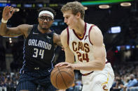 Cleveland Cavaliers' Lauri Markkanen (24) drives against Orlando Magic's Wendell Carter Jr. (34) in the second half of an NBA basketball game, Saturday, Nov. 27, 2021, in Cleveland. The Cavaliers won 105-92. (AP Photo/Tony Dejak)
