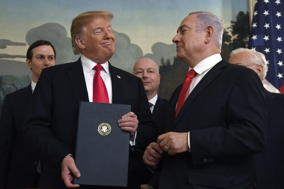 FILE - In this March 25, 2019 file photo, President Donald Trump smiles at Israeli Prime Minister Benjamin Netanyahu, right, after signing an official proclamation formally recognizing Israel's sovereignty over the Golan Heights, in the Diplomatic Reception Room at the White House in Washington. As Netanyahu becomes Israel’s longest-serving prime minister, he is solidifying his place as the country’s greatest political survivor and the most dominant force in Israeli politics in his generation. (AP Photo/Susan Walsh, File)