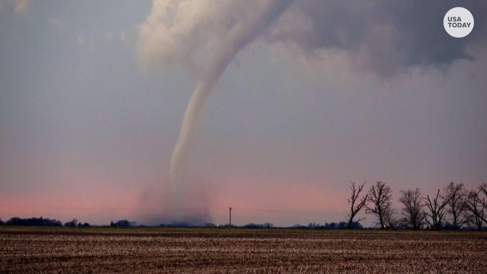 A long, rope-shaped tornado tears across Iowa in April 2023.