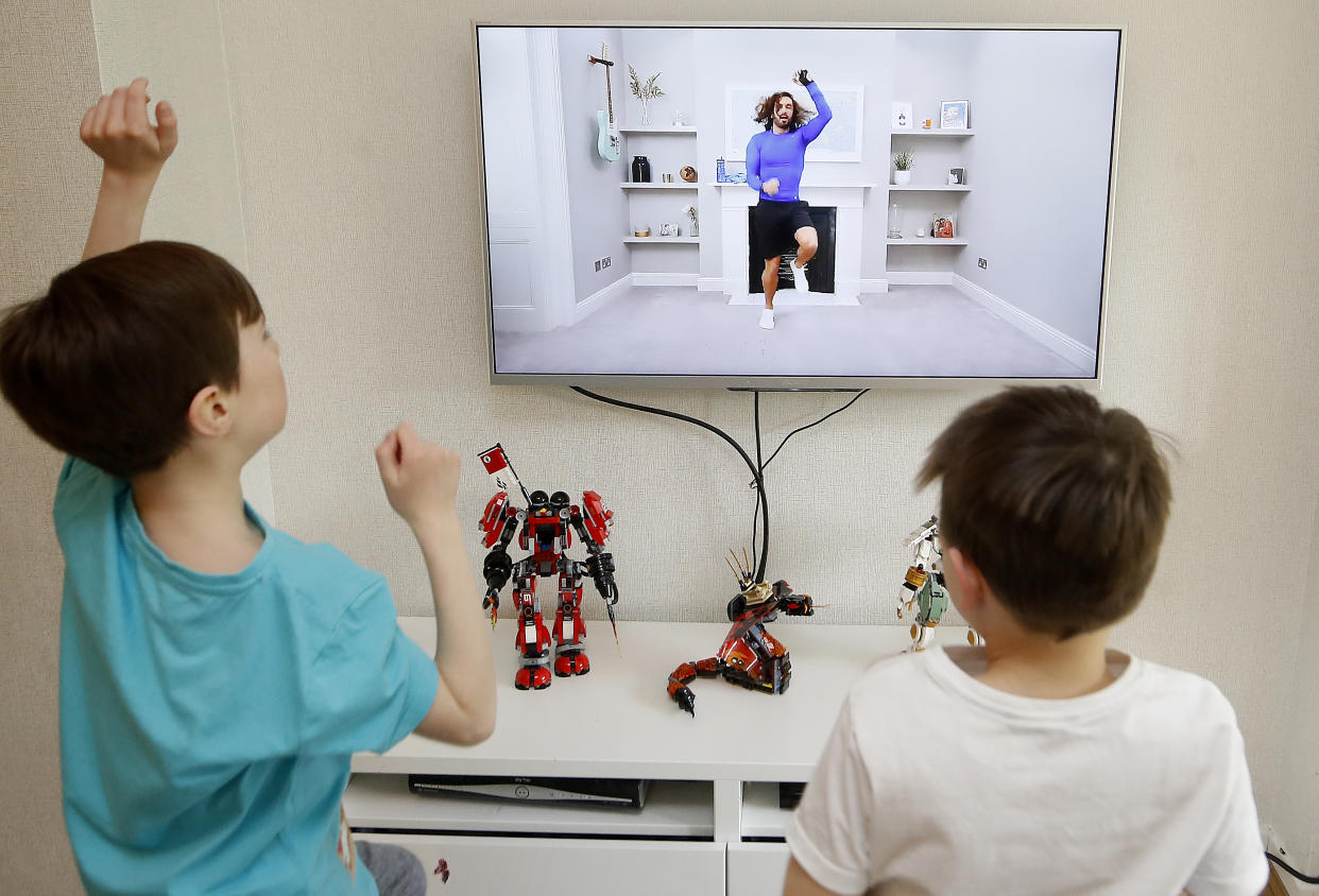 Ben and Isaac Rickett follow P.E with Joe, a fitness workout by Joe Wicks that is aimed at children that are being home schooled due to Covid-19. (Photo by Martin Rickett/PA Images via Getty Images)