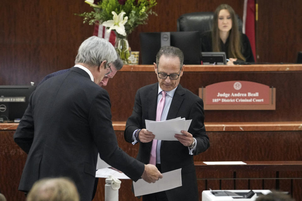 Prosecutor pro tem Brian Wice, center, talks with defense attorneys for Texas Attorney General Ken Paxton during a hearing in his securities fraud case, Friday, Feb. 16, 2024, at the Harris County criminal courthouse in Houston. A judge on Friday rejected Paxton’s attempts to throw out felony securities fraud charges that have shadowed the Republican for nearly a decade. (Jon Shapley/Houston Chronicle via AP)