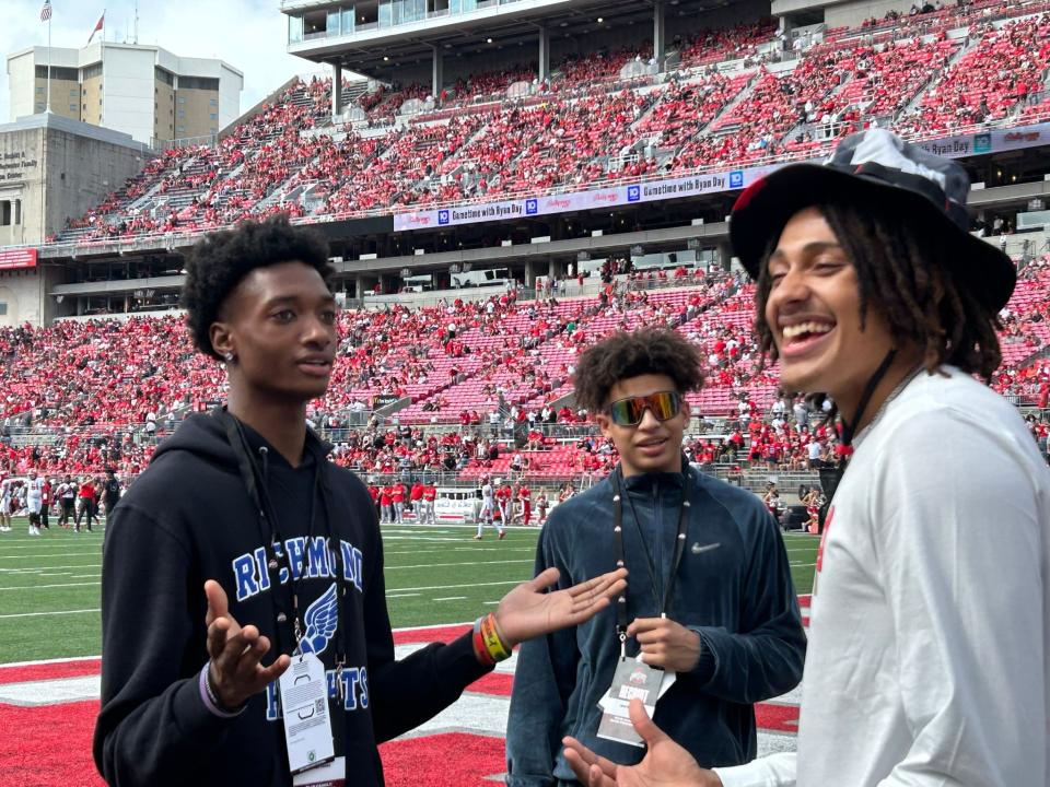 Richmond Heights' Dorian Jones gestures to Ohio State's Devin Royal as John "Juni" Mobley Jr. looks on at Ohio Stadium on Sept. 9, 2023.