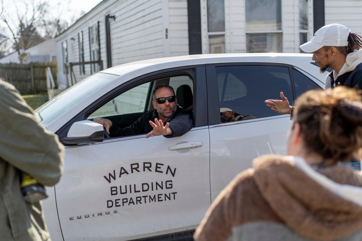 City of Warren building inspector John Impellizzeri, center, talks with Landmark Estates residents, Mark Brown, left, and his wife, Amanda Brown, as well as Blaer Roberts, right, at their mobile home park in Warren on Monday, Feb. 26, 2024.