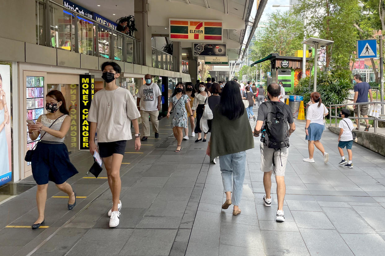 People seen walking along Orchard Road, in front of the Lucky Plaza mall, on 15 May 2021. (PHOTO: Dhany Osman / Yahoo News Singapore)