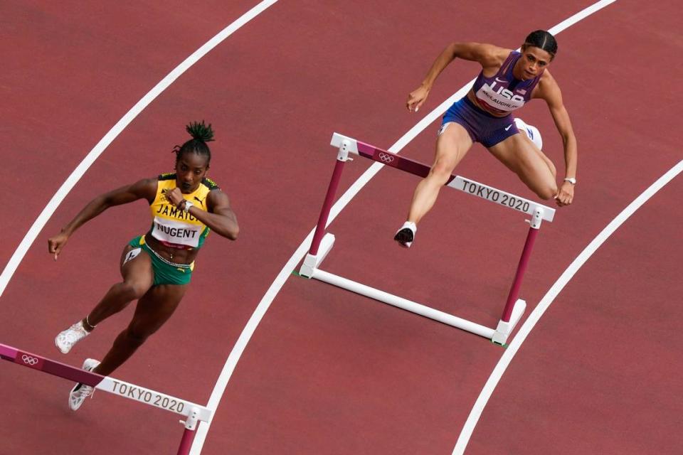 Sydney McLaughlin, right, won her heat in the women’s 400-meter hurdles on Saturday. She will try to give former Kentucky Wildcats stars a sweep of the Olympics women’s hurdles events when she runs in the finals Tuesday night.