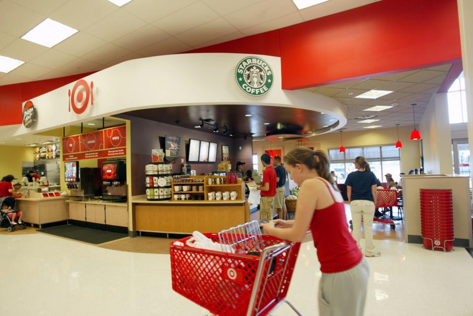 A file photo of a Target shopper stopping in front of an in-store Starbucks kiosk.