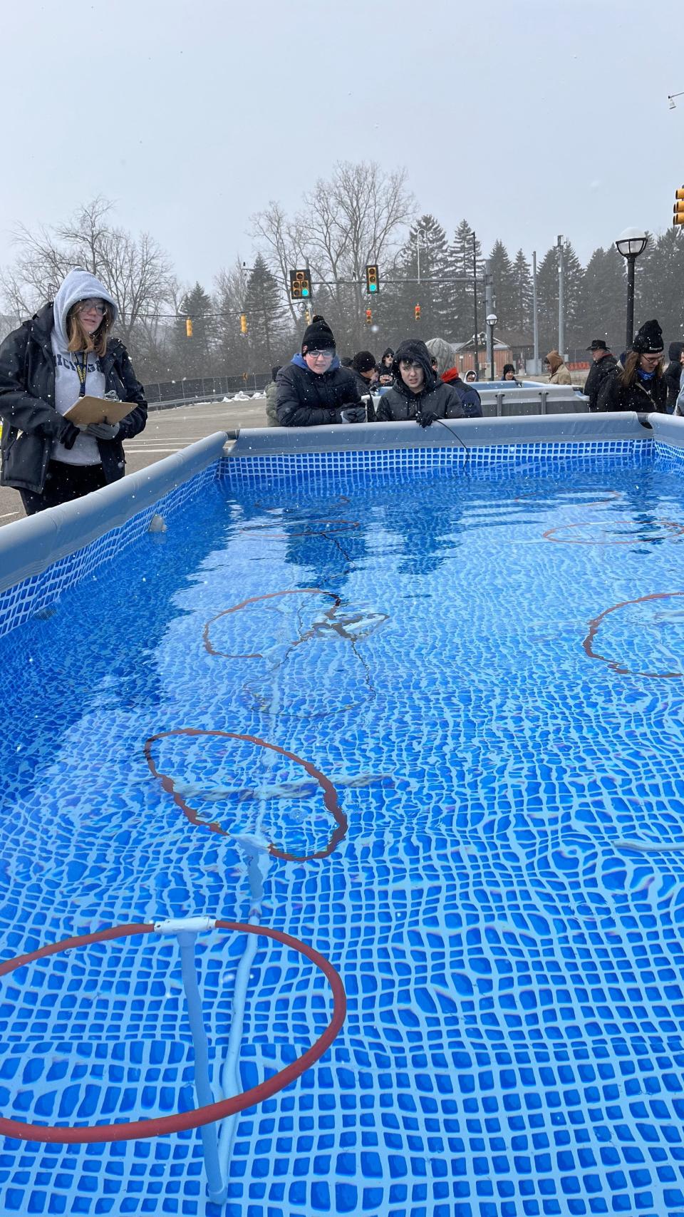 Clinton Middle School students, from left, Shawn Baughey and Brandon Ruhl of Team The SSS maneuver their underwater robot through the Obstacle Hoops Course during the Michigan Regional SeaPerch Underwater Robotics Competition March 18 at the University of Michigan in Ann Arbor.