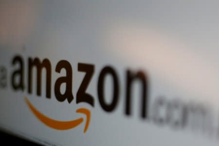 FILE PHOTO: The logo of the web service Amazon is pictured in this June 8, 2017 illustration photo. REUTERS/Carlos Jasso/File Photo