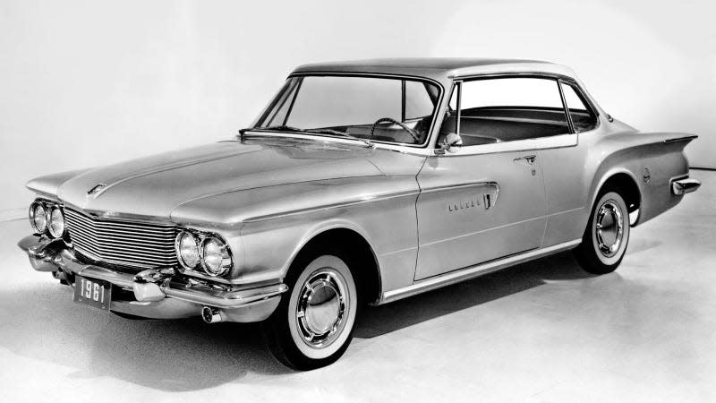 A black and white photo of a Dodge Lancer. 