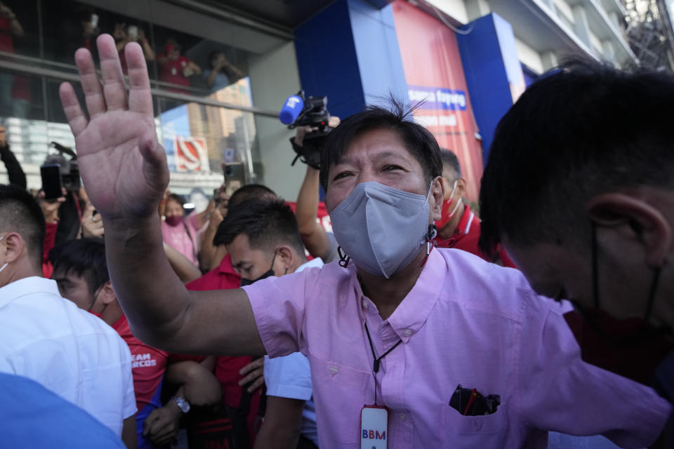 Presidential candidate Ferdinand "Bongbong" Marcos Jr. greets the crowd as he celebrates outside his headquarters in Mandaluyong, Philippines on Wednesday, May 11, 2022. Marcos, the namesake son of longtime dictator Ferdinand Marcos, apparent landslide victory in the Philippine presidential election is raising immediate concerns about a further erosion of democracy in Asia and could complicate American efforts to blunt growing Chinese influence and power in the Pacific. (AP Photo/Aaron Favila)