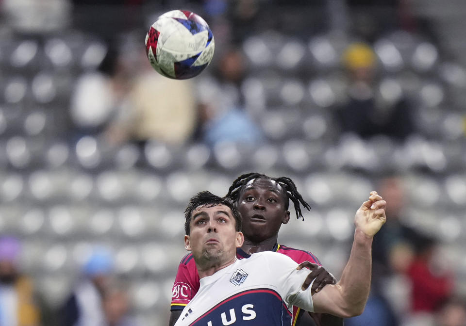 Vancouver Whitecaps' Brian White, front, and St. Louis City's Joshua Yaro vie for the ball during the first half of an MLS soccer match Wednesday, Oct. 4, 2023, in Vancouver, British Columbia. (Darryl Dyck/The Canadian Press via AP)