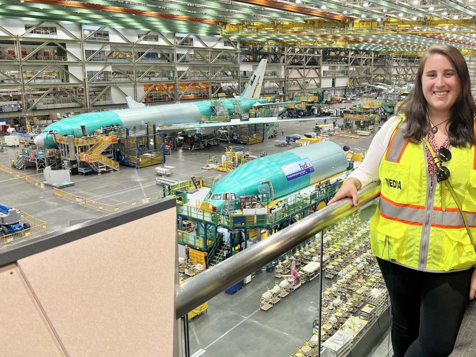 Standing at the Boeing 777 assembly line with two in-production aircraft in the background.