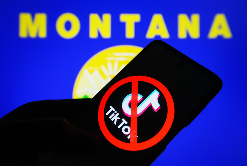 A crossed-out TikTok logo is seen on a smartphone screen in front of a flag of the state of Montana. / Credit: Pavlo Gonchar/SOPA Images/LightRocket via Getty Images
