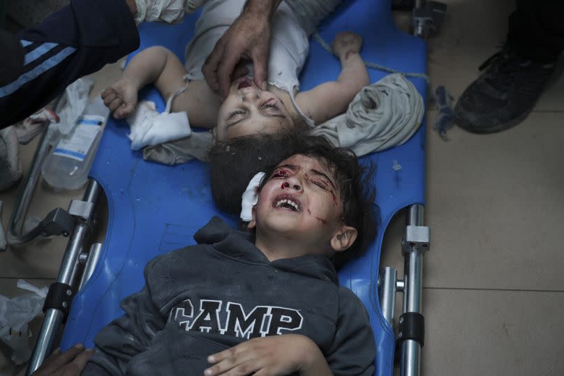 FILE - Palestinians wounded in the Israeli bombardment of the Gaza Strip are brought to a hospital in Deir al-Balah on Wednesday, Nov. 15, 2023.