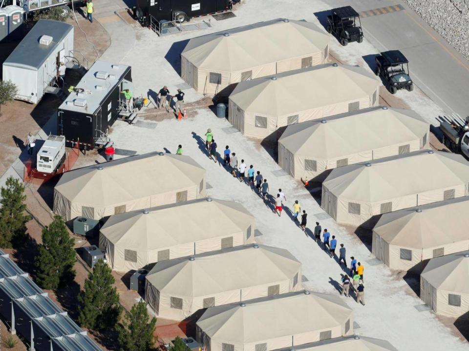 Immigrant children now housed in a tent encampment under the new 'zero tolerance' policy by the Trump administration are shown walking in single file at the facility near the Mexican border in Tornillo, Texas (REUTERS/Mike Blake)