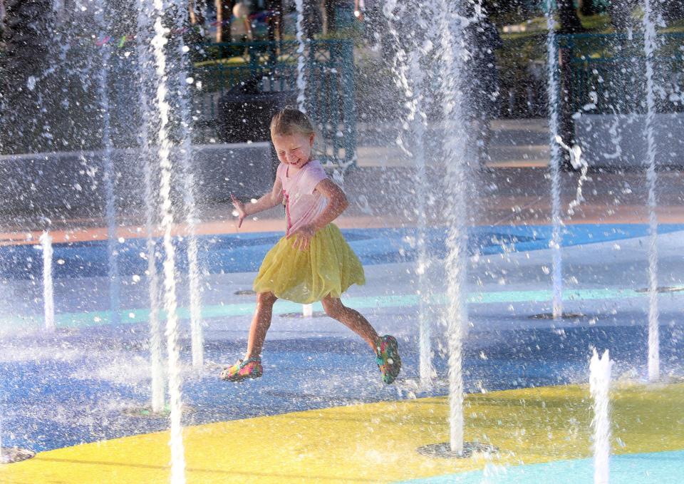 Four-year-old Ember Caldwell was one of the first people on Thursday to run through the fountains on the splash pad at Daytona Beach's new southern Riverfront Esplanade.