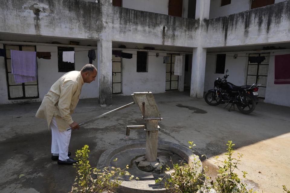 Farmer Ramkrishan Malawat takes out water from a hand pump which is on its last leg in Bawal, in the Indian state of Haryana, Thursday, March 7, 2024. “There is so much construction around here and when it rains now, the water just flows away” rather than seeping into the ground and replenishing stocks, Malawat said. (AP Photo/Manish Swarup)