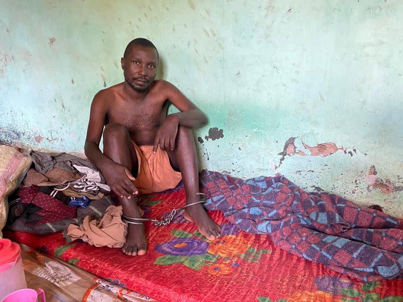 A man sits shackled at the ankles in a room at the Coptic Church Mamboleo, in Kisumu city