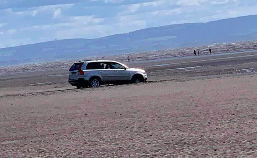 A couple's car was stranded after they tried to park close to the sea at Burnham-on-Sea, Somerset (SWNS)