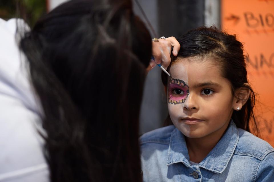 Seven-year-old I'marie Salazar gets her face painted at Dia de los Muertos Street Festival, Saturday, Nov. 2, 2019.