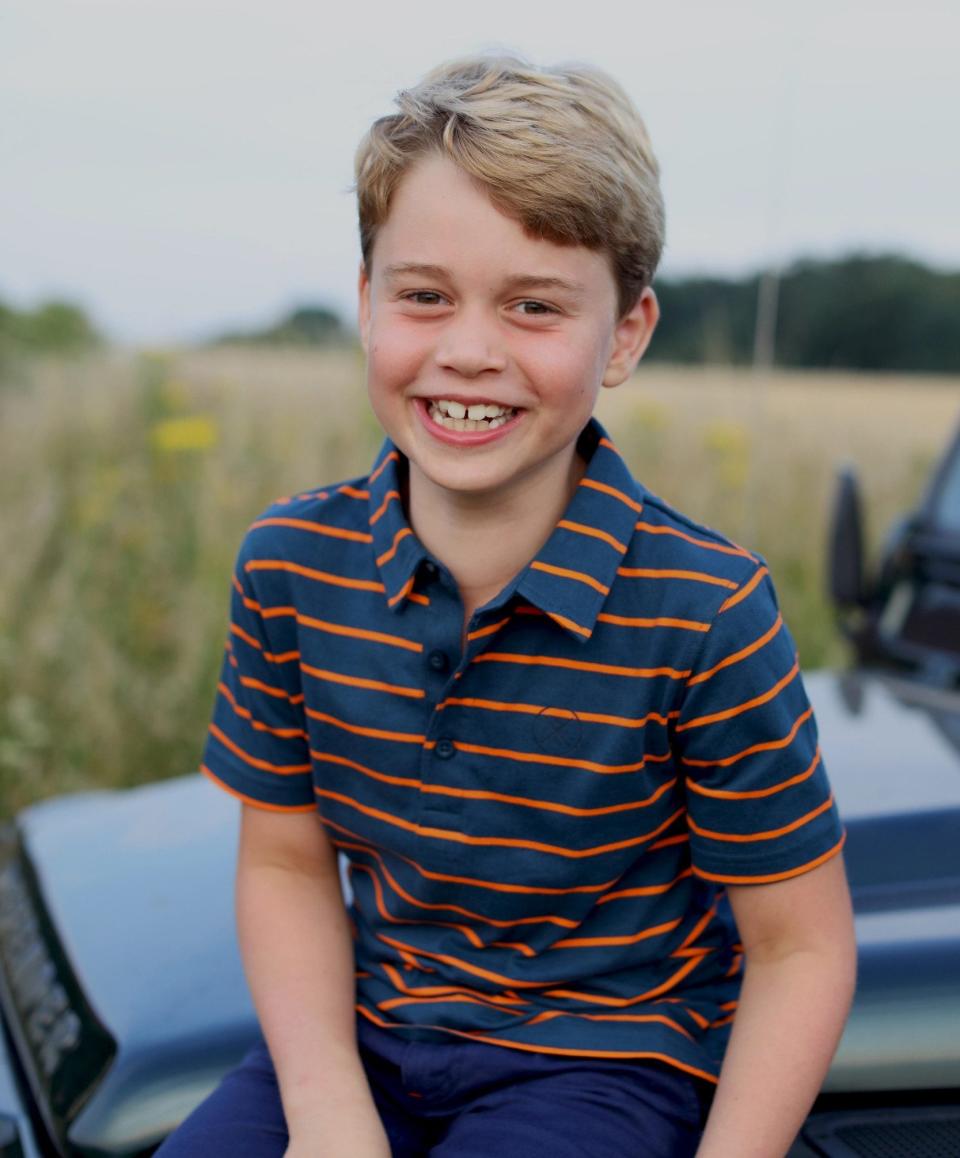 Prince George sits on the bonnet of a Land Rover Defender in this photograph taken by his mother, The Duchess of Cambridge, to mark his eighth birthday - HRH The Duchess of Cambridge