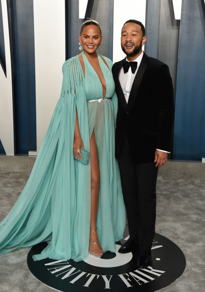 Chrissy Teigen (pictured with husband John Legend) took to social media to share a "thirst trap" video of herself in a swimsuit . (Photo by John Shearer/Getty Images)