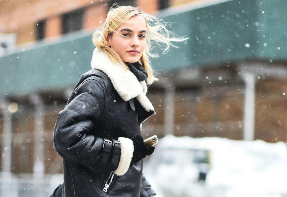 <p>A model wears a chic black-and-white shearling moto coat — the only one you’ll need in your wardrobe to stay on top of your style game throughout the cold, winter months. You can easily pair it with trousers, jeans, or even leggings, and still look edgy. (Photo: Getty Images) </p>