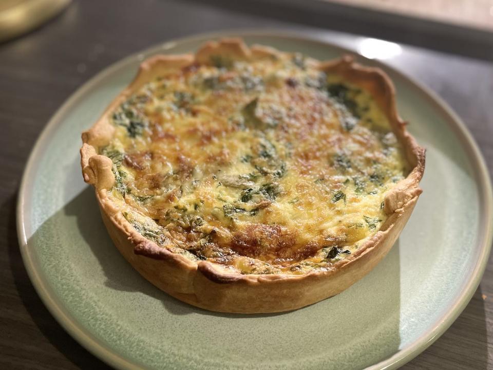 A finished Coronation Quiche, on a pale green plate.