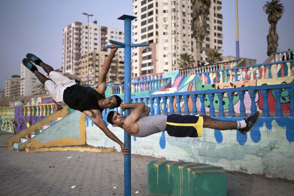 Palestinian group, Bar Palestine, take part in street exercises on the coast in Gaza City on August 2, 2015. Street workout, that is still new to Gaza, is a growing sport across the world with annual competitions and events.