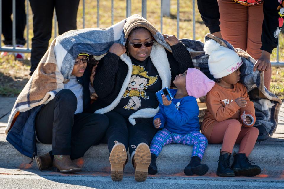 Jakayden Hall, left, Dorothy Powell, Kamari Hall and Kali Hall bundle up during the Martin Luther King Jr. Day Parade in Riviera Beach, Florida on January 14, 2023. 