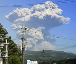 <p>A column of volcanic smoke rises from the Shinmoedake volcano in Yusui town, Kagoshima prefecture, southern Japan, May 14, 2018. The volcano seen in a James Bond film has erupted, shooting up grey smoke and ash thousands of meters (feet) into the sky. (Photo: Tatsuya Suga/Kyodo News/AP) </p>