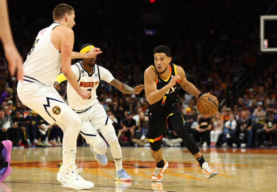 The Phoenix Suns' Devin Booker drives to the basket against the Denver Nuggets during Game 4.