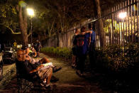 Fans wait in hopes of getting players' autographs outside Roger Dean Stadium where negotiations over a labor agreement continued Monday, Feb. 28, 2022, in Jupiter, Fla. (AP Photo/Lynne Sladky)