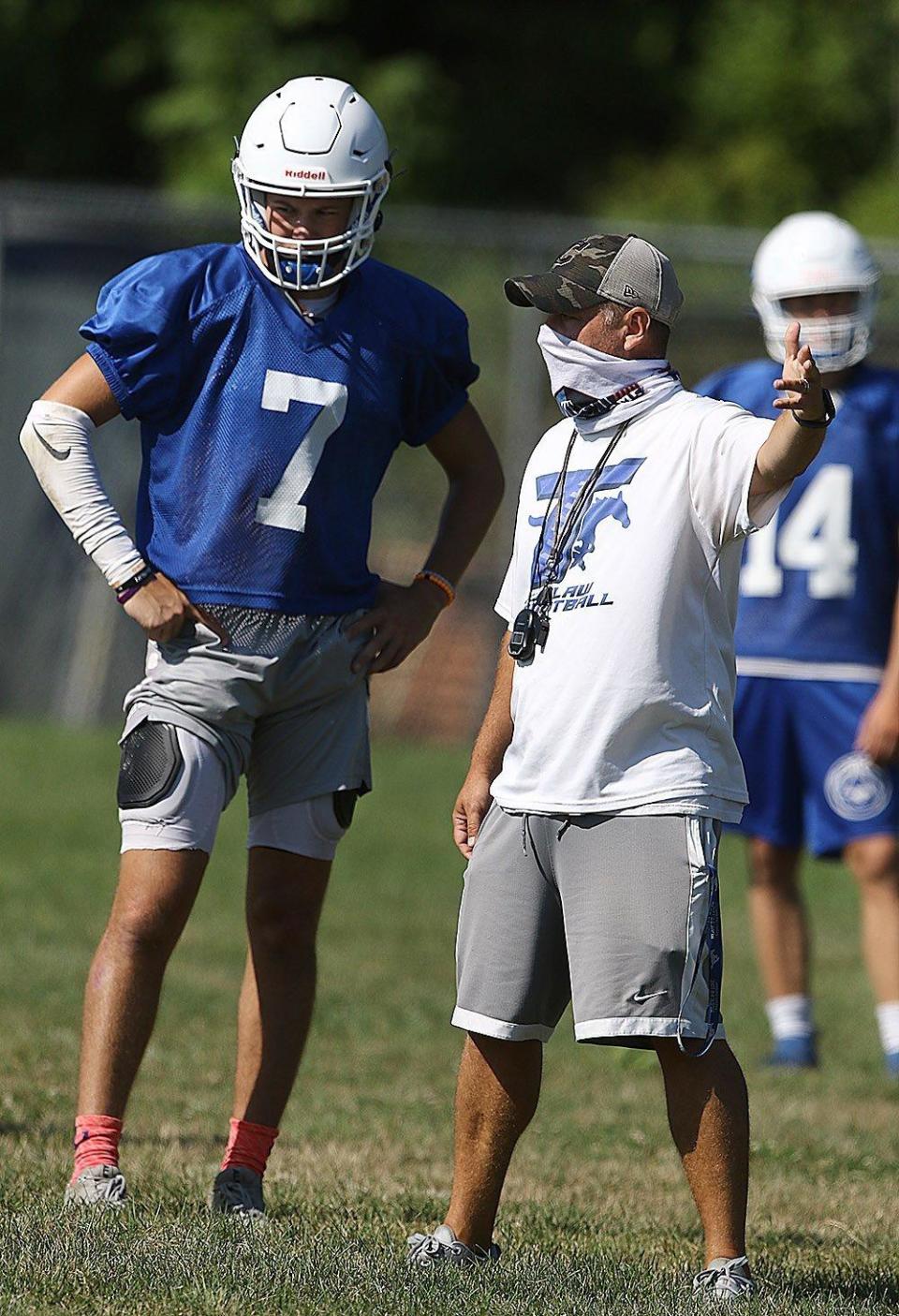 Tuslaw football coach Matt Gulling works with a Mustangs player during a 2020 practice. Gulling starts his third season at Tuslaw this season.
