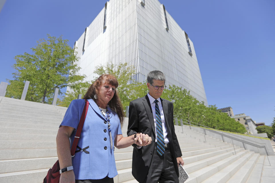 Mike and Becky Shamo, the parents of Aaron Shamo, walk from the federal courthouse Monday, Aug. 12, 2019, in Salt Lake City. Former Eagle Scout Aaron Shamo, 29, will stand trial on allegations that he and a small group of fellow millennials ran a multimillion-dollar empire from the basement of his suburban Salt Lake City home by trafficking hundreds of thousands of pills containing fentanyl, the potent synthetic opioid that has exacerbated the country's overdose epidemic in recent years. (AP Photo/Rick Bowmer)