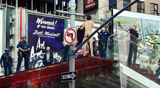 New York Model Krit McClean talks with police during his hour-long spectacle in Times Square. Source: AP