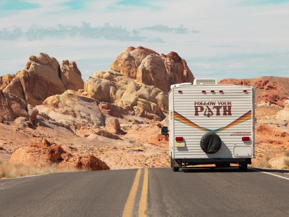 The back of their camper says "Follow your Path," a nod to their company name Path Design.