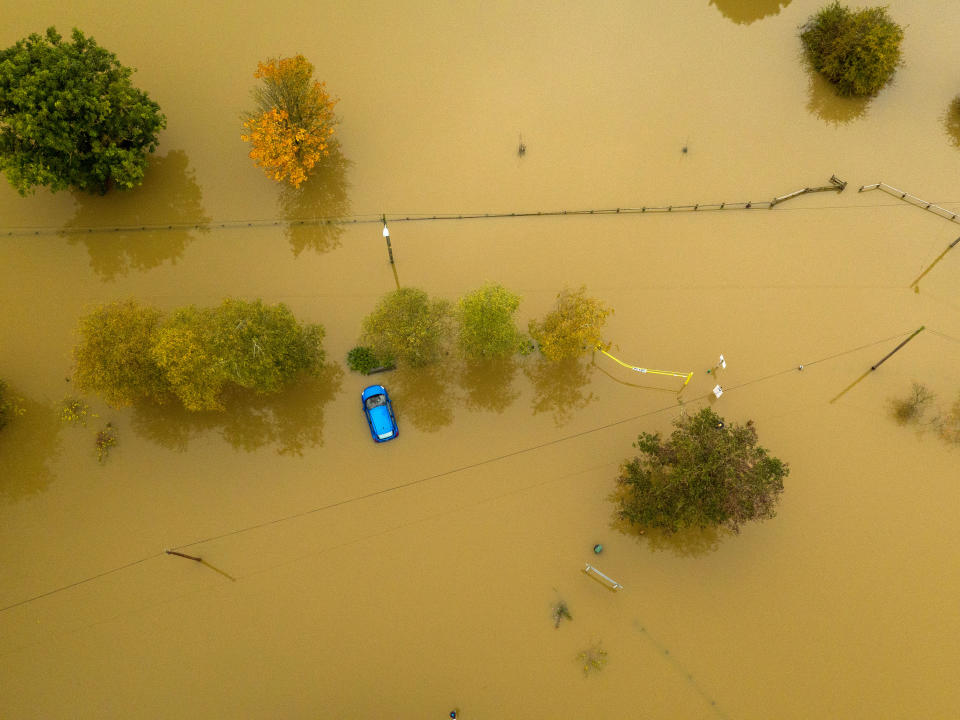 An aerial view of a car caught in flood water in Tewkesbury, Gloucestershire, as the UK has been hit by widespread flooding after rivers burst their banks following the weekend???s heavy rain.