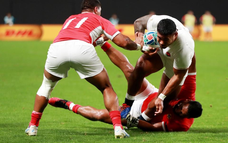 Manu Tuilagi of England is tackled by Cooper Vuna of Tonga - GETTY IMAGES