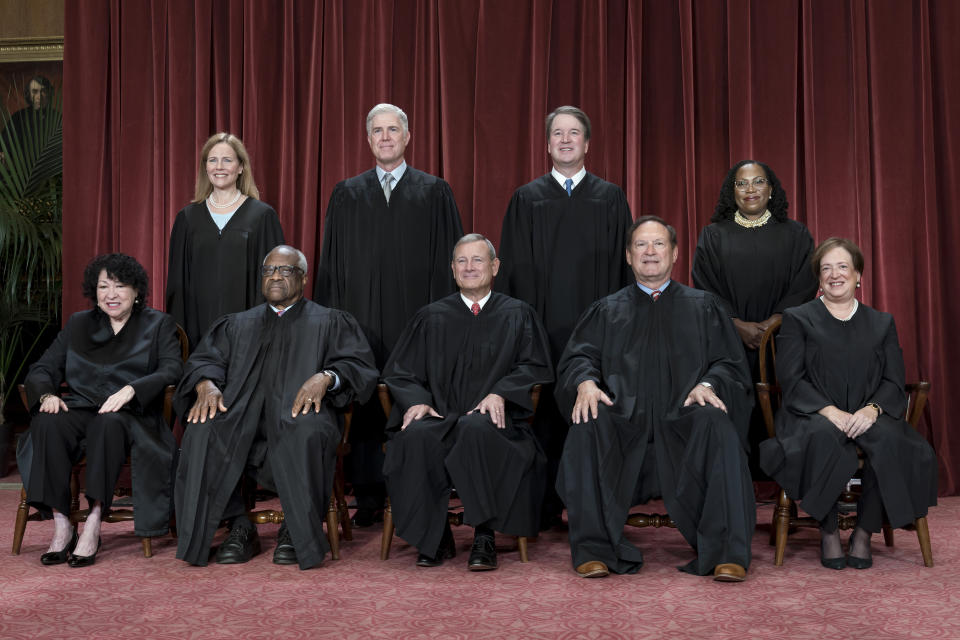 FILE - Members of the Supreme Court sit for a new group portrait following the addition of Associate Justice Ketanji Brown Jackson, at the Supreme Court building in Washington, Oct. 7, 2022. Bottom row, from left, Justice Sonia Sotomayor, Justice Clarence Thomas, Chief Justice John Roberts, Justice Samuel Alito, and Justice Elena Kagan. Top row, from left, Justice Amy Coney Barrett, Justice Neil Gorsuch, Justice Brett Kavanaugh, and Justice Ketanji Brown Jackson. The Supreme Court is adopting its first code of ethics, in the face of sustained criticism over undisclosed trips and gifts from wealthy benefactors to some justices. The policy was issued by the court Monday. (AP Photo/J. Scott Applewhite, File)